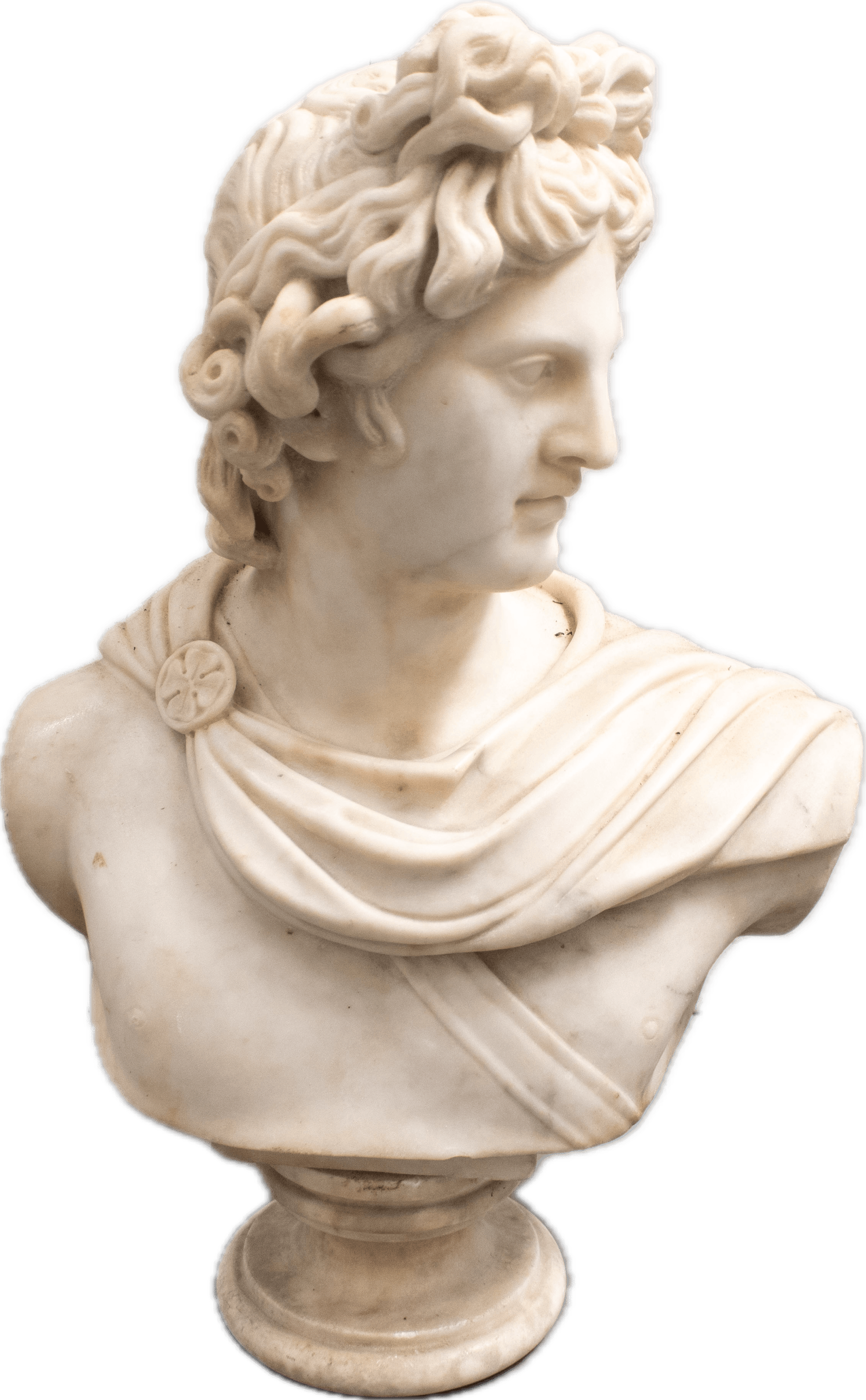 A classical marble bust of Apollo with idealized features, flowing curly hair, and draped garment secured with a medallion, carved in the Neoclassical tradition after ancient Greek and Roman models.